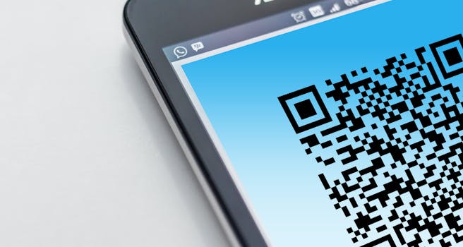 High-resolution close-up of a smartphone displaying a QR code on its screen.