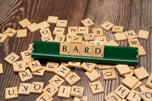 Scattered wooden tiles displaying letters with the word BARD on a green rack.