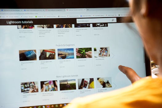 Woman exploring Lightroom tutorials on computer screen, perfect for online education themes.