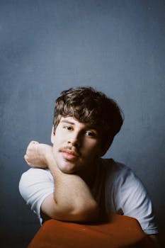 Casual portrait of a young man with mustache in a studio setting, Breves, Brazil.